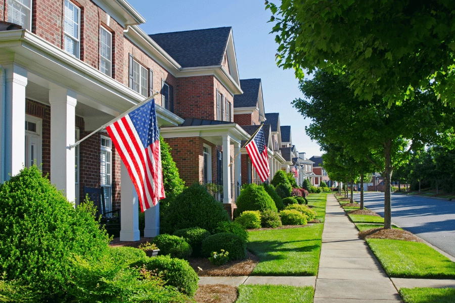 traditional neighborhood with houses that have American flags and front porches